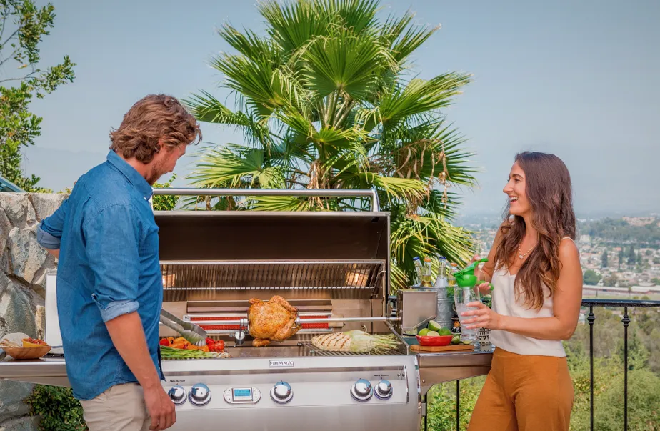 Cheerful couple grilling at a FireMagic grill