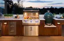 FireMagic grill on a classy terrace, framed by a row of cabinets in dark brown wood