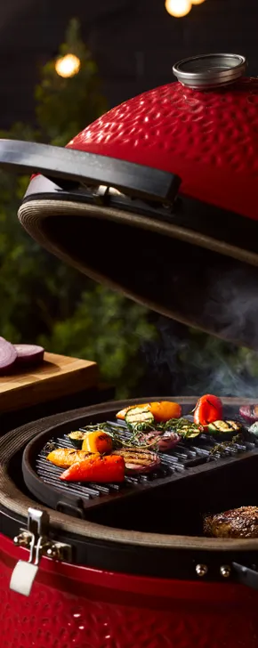 Close-up of a Kamado Joe grill loaded with food